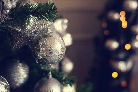 Silver Christmas balls on a fir branch.の写真素材