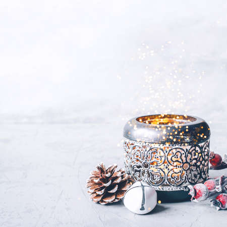 A composition of candlestick, snow branches and Christmas decorations on gray background.の写真素材