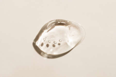 Transparent hyaluronic acid gel on a beige background.の写真素材