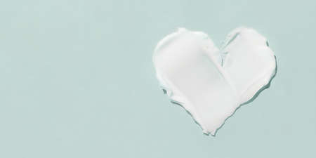 A smear of cosmetic cream on a blue background