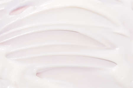 Texture of cream on a pink background.の写真素材