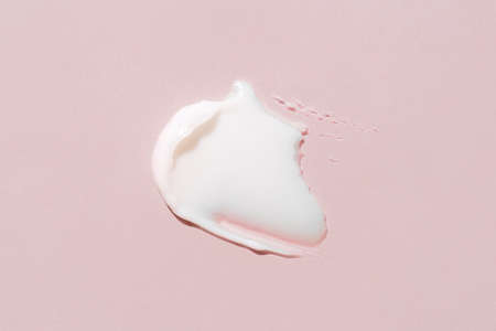 Smear of cream on a pink background.の写真素材