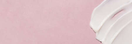 Smear of cream on a pink background.の写真素材