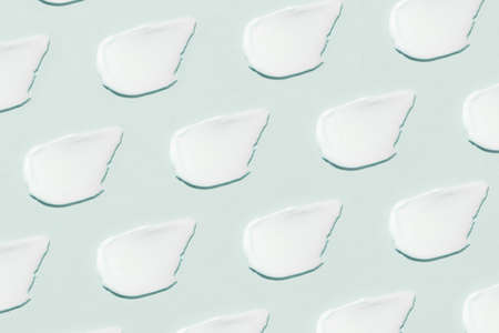 Smears of cream on a blue background.の写真素材