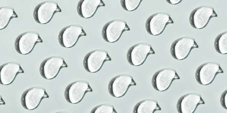 Transparent hyaluronic acid gel on a gray background.の写真素材