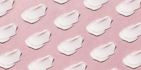 Smear of cream on a pink background.の写真素材