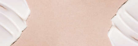 Smear of cream on a beige background.の写真素材