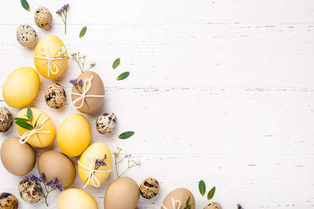 Easter eggs with flowers on a white table.の写真素材