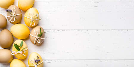 Easter eggs with flowers on a white table.の写真素材