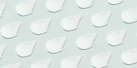 Smears of cream on a blue background.の写真素材