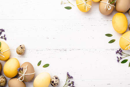 Easter eggs with flowers on a white table.の写真素材