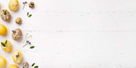 Easter eggs with flowers on a white table.の写真素材