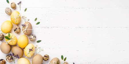 Easter eggs with flowers on a white table.の写真素材