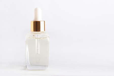 Transparent dropper bottle with cosmetic product.の写真素材