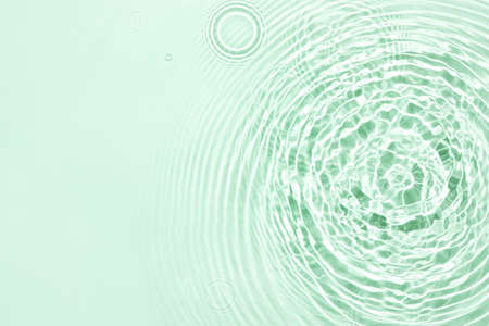 The texture of water on a green background.の写真素材