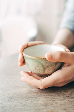 Womens hands hold a cup of tea.の写真素材