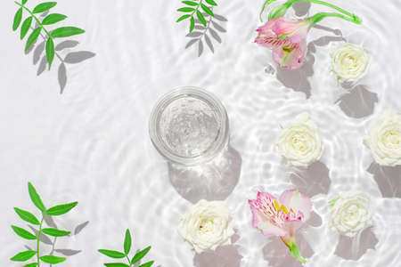 Jar of hydrating gel and flowers.の写真素材