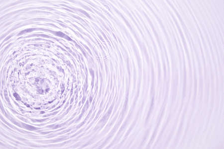 The texture of water on a lilac background.の写真素材