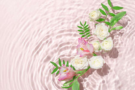 Sunny summer cosmetic background with flowers.の写真素材