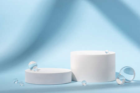 White podium with glass balls on a blue background.