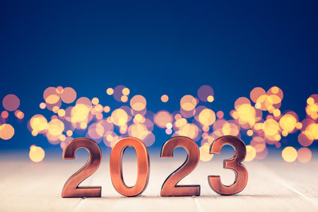 Metal numbers 2023 on table with bokeh lights.の写真素材