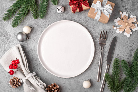 Christmas place setting on gray table.の写真素材