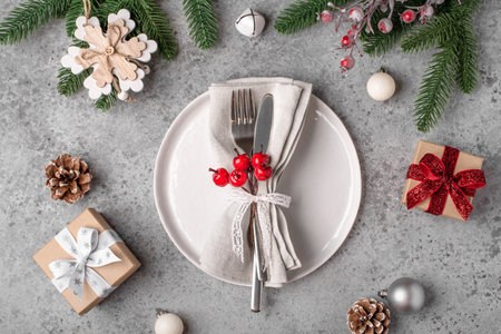 Christmas place setting on gray table.の写真素材
