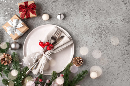 Christmas place setting on gray table.の写真素材