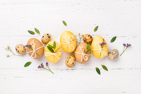 Easter eggs with flowers on a white table.の写真素材