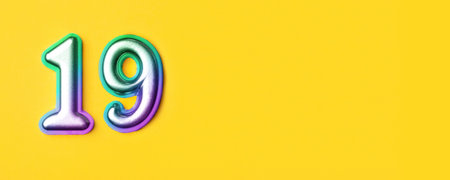 19 years celebration. Banner with birthday greetings. Multi colored metal number nineteen on a yellow background. Copy space, top view.の写真素材