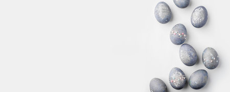 Gray-blue Easter eggs with stars on a white table.の写真素材