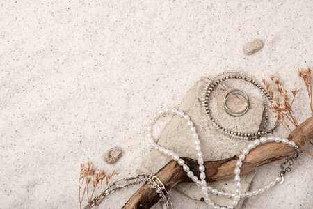 Beautiful Silver and Pearl Jewelry on white sand.の写真素材