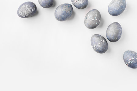 Gray-blue Easter eggs with stars on a white table.の写真素材