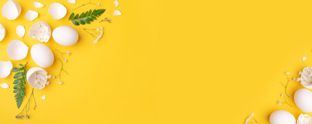 White Easter eggs and shells on a bright yellow background.の写真素材