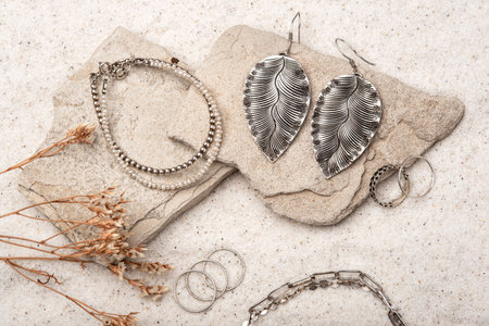 Beautiful Silver and Pearl Jewelry on white sand.の写真素材