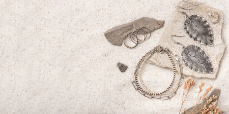 Beautiful Silver and Pearl Jewelry on white sand.の写真素材