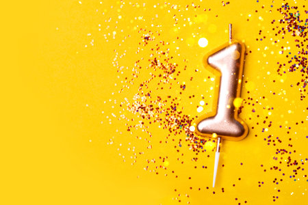 Gold candle in the form of number one.の写真素材