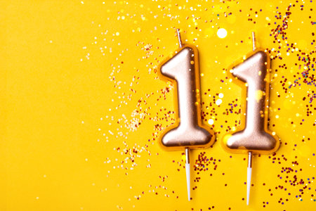 Gold candles in the form of number eleven.の写真素材