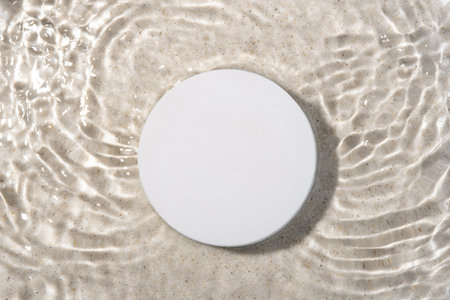 Round white podium for cosmetics on the water surface.の写真素材