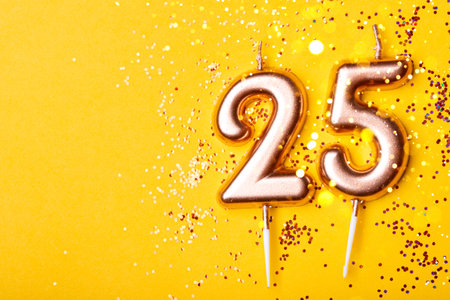 Gold candles in the form of number twenty five.の写真素材