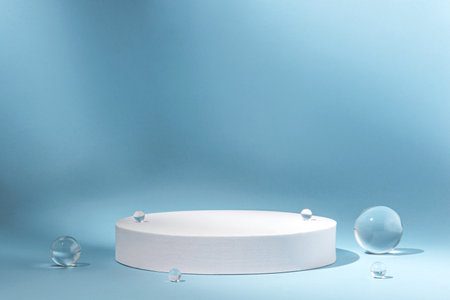 White podium with glass balls on a blue background.の写真素材