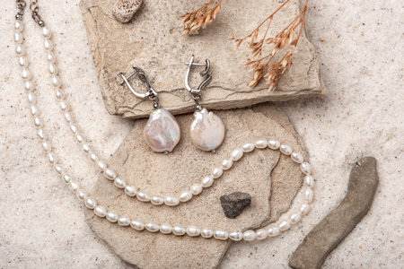 Beautiful Pearl Jewelry on white sand.