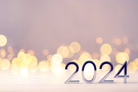 Metal numbers 2024 on a white table with Christmas trees and bokeh lights. Happy New Year 2024 is coming concept.の写真素材