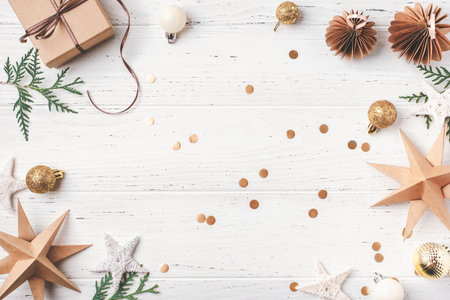 Festive Christmas background with gift box and Christmas decorations on white wooden table. Top view. Copy space for text.の写真素材