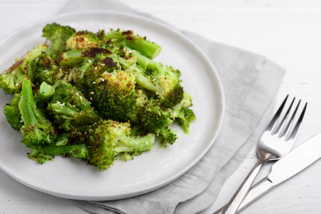 Fried broccoli inflorescences on a plate on a white table.の写真素材