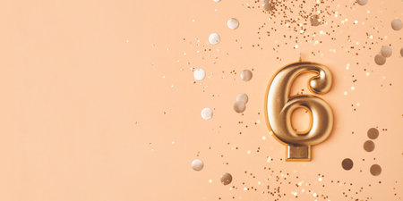 Gold candle in the form of number six.の写真素材