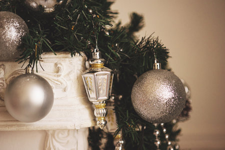 Silver Christmas decorations on a fir branch. The image is in soft focus.の写真素材