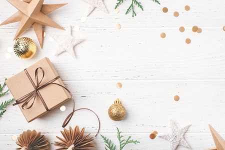Festive Christmas background with gift box and Christmas decorations on white wooden table. Top view. Copy space for text.の写真素材