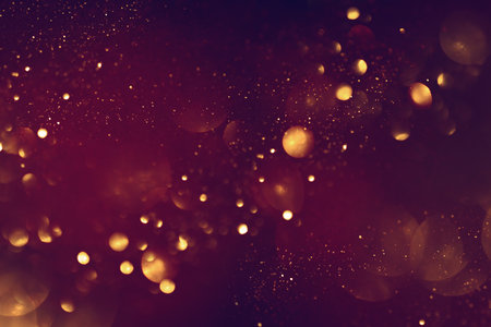 Golden abstract bokeh on black background. Celebrating Christmas, New Year or other holidays.の写真素材