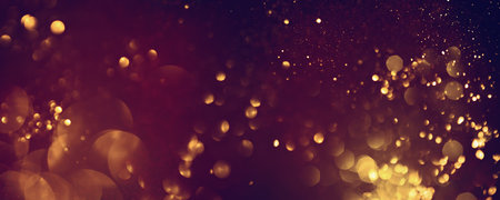 Golden abstract bokeh on black background. Celebrating Christmas, New Year or other holidays.の写真素材